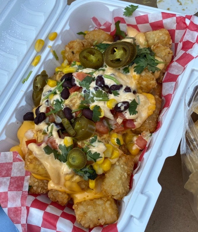 Taco tater tots loaded with queso, corn and fresh cilantro at Don Taco Calgary
