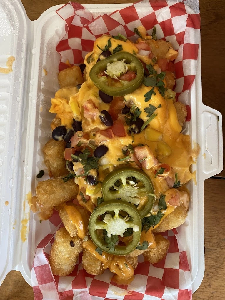 Taco tater tots topped with melted queso and fresh jalapenos at Don Taco Calgary